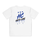A white youth athletic tee features a bold blue HC emblem with three stars above it, and the words HATTY CORE in a playful, streetwise font. The design includes dripping paint effects, adding a dynamic touch to the shirt.